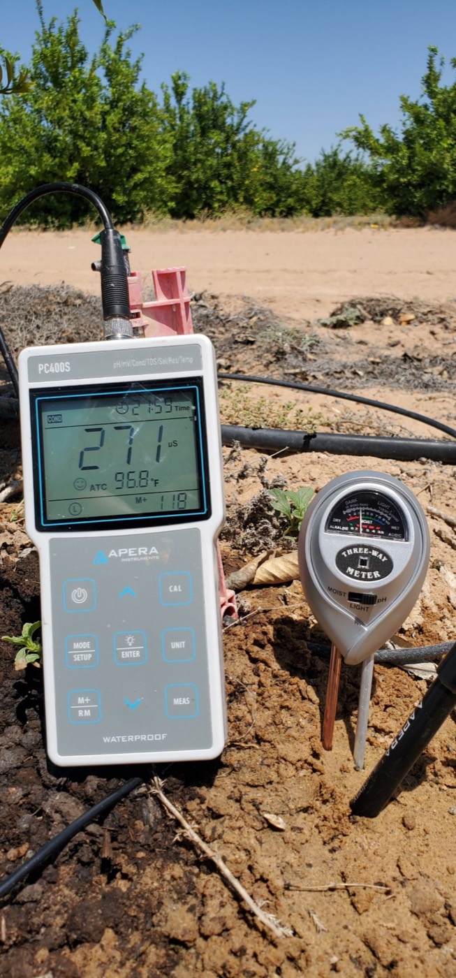 Digital soil meter taking a reading in a treated field